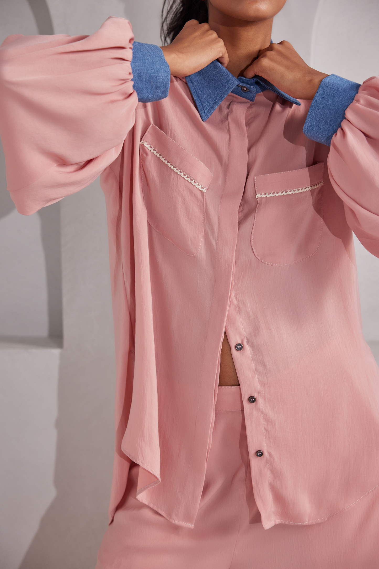 Front button closure, Denim collared shirt with 2 pockets on front, Padded shoulders with denims and balloon sleeves. White net design at the back. Flared pants with netted patches on side bottoms