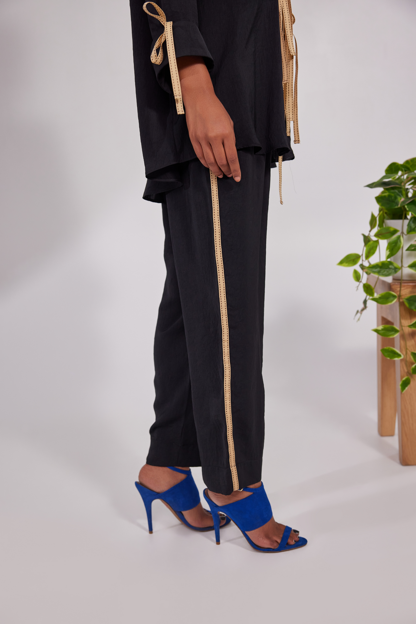 Collared shirt with ribbrons instead of traditional buttons and pockets positioned diagonally up and down with pocket pants
