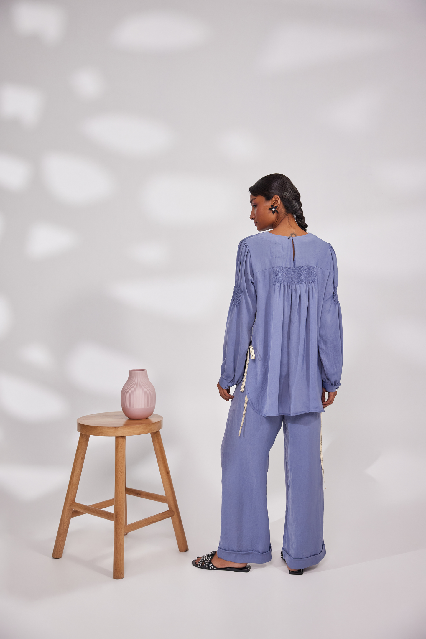 Full sleeves round neck tunic top with elastic on the biceps and back. Pocketed pants.