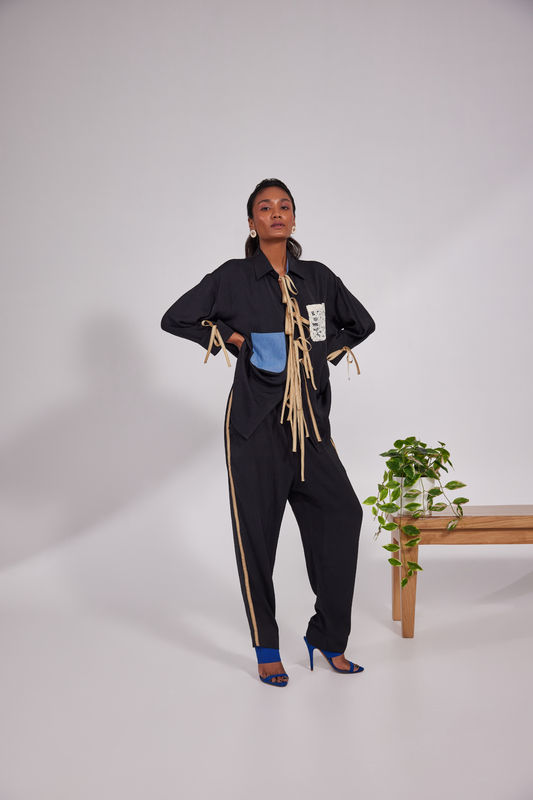 Collared shirt with ribbrons instead of traditional buttons and pockets positioned diagonally up and down with pocket pants