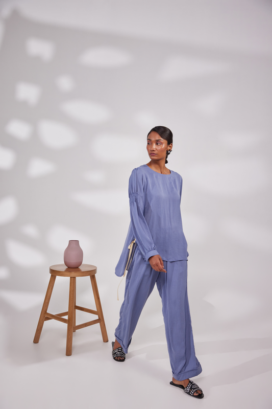 Full sleeves round neck tunic top with elastic on the biceps and back. Pocketed pants.