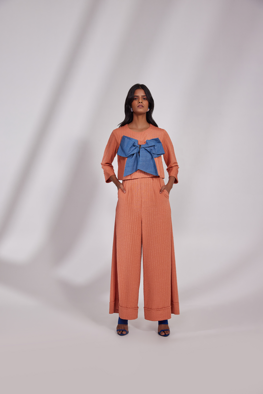 Full sleeves round neck top with a Denim bow on the front and pocketed pants folded on hem